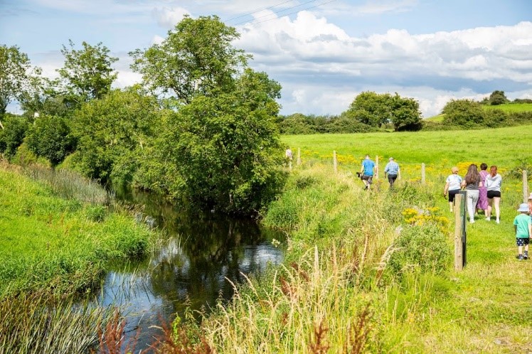 People walking by river